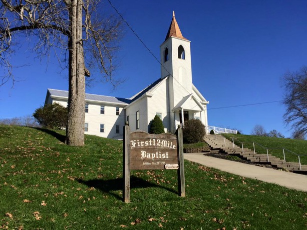 green grass brown sign church